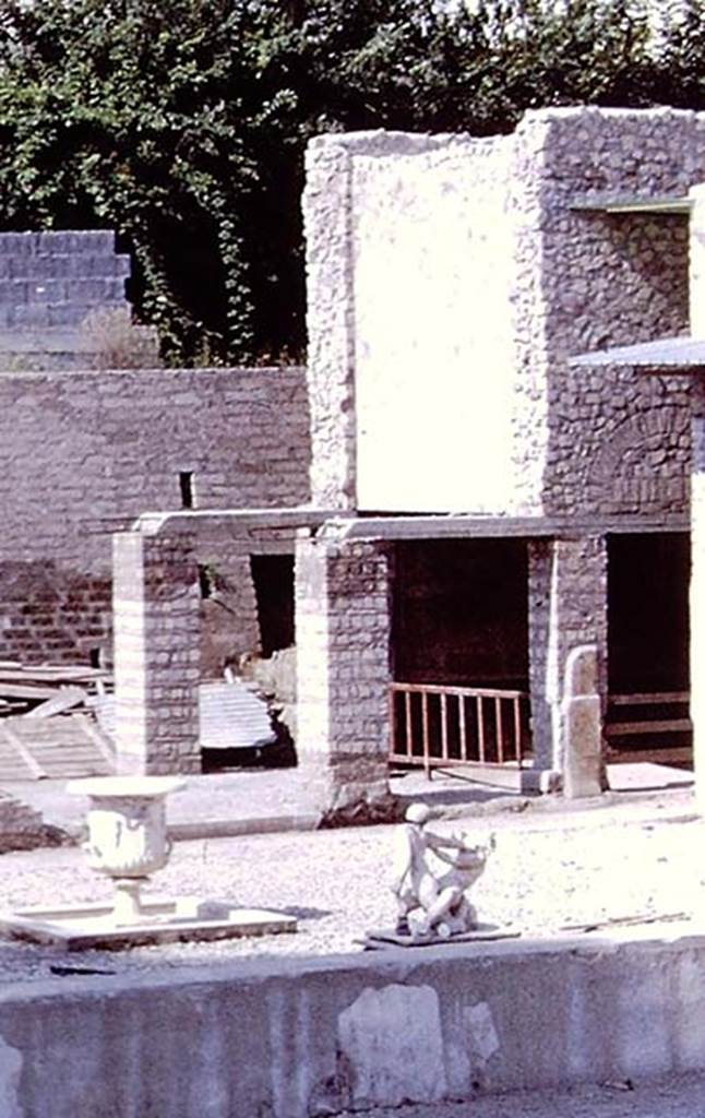Oplontis Villa of Poppea, 1978. Room 84 is behind the pillars, at the east end of area 91, at the south end of the swimming pool 95.
Detail from photo by Stanley A. Jashemski.
Source: The Wilhelmina and Stanley A. Jashemski archive in the University of Maryland Library, Special Collections (See collection page) and made available under the Creative Commons Attribution-Non Commercial License v.4. See Licence and use details.
J78f0045