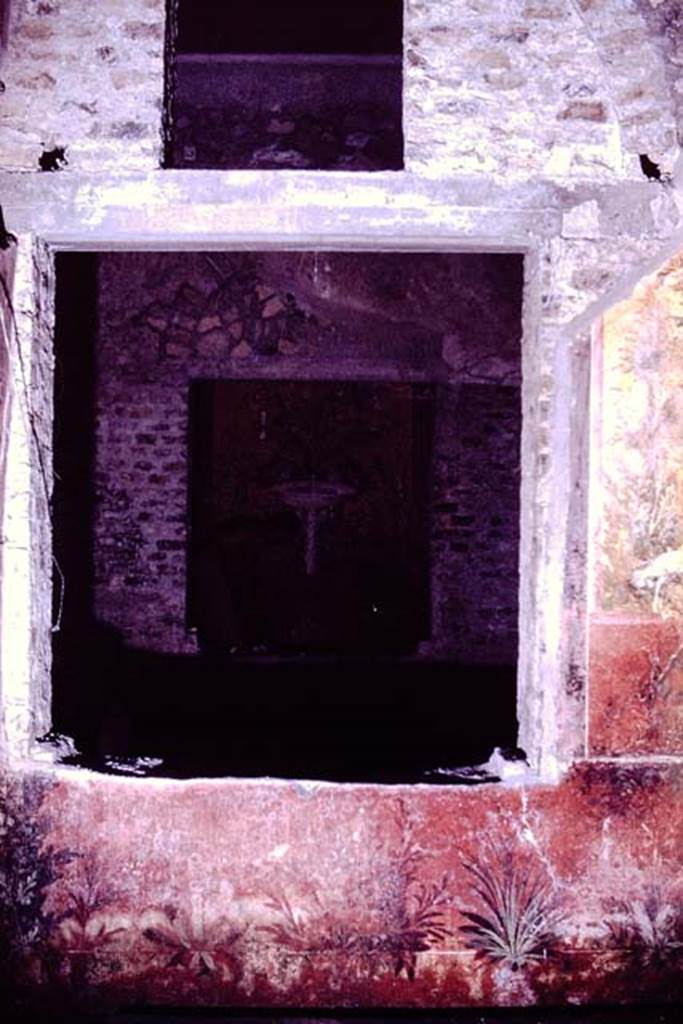 Oplontis, 1976. According to Wilhelmina, this is a window from room 68, a small courtyard-garden where they excavated and found some root-cavities, looking south through the window across room 65, and through another window into room 61.  Photo by Stanley A. Jashemski.   
Source: The Wilhelmina and Stanley A. Jashemski archive in the University of Maryland Library, Special Collections (See collection page) and made available under the Creative Commons Attribution-Non Commercial License v.4. See Licence and use details. J76f0412
According to Wilhelmina, �Stanley took many pictures of the garden paintings on the walls of this garden, also of the view from this garden through the adjacent room to the unique little raised garden with garden paintings beyond.�
