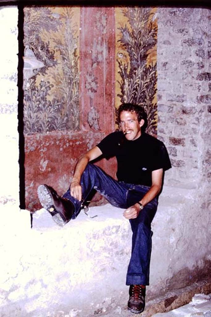 Oplontis, 1976. Room 65, south wall with window into room 61. Photo by Stanley A. Jashemski.   
Source: The Wilhelmina and Stanley A. Jashemski archive in the University of Maryland Library, Special Collections (See collection page) and made available under the Creative Commons Attribution-Non Commercial License v.4. See Licence and use details. J76f0409
According to Wilhelmina, �Mike posed for a photo sitting on the edge of the little raised garden�.
See Jashemski, W.F., 2014. Discovering the Gardens of Pompeii: Memoirs of a Garden Archaeologist, (p.248)
