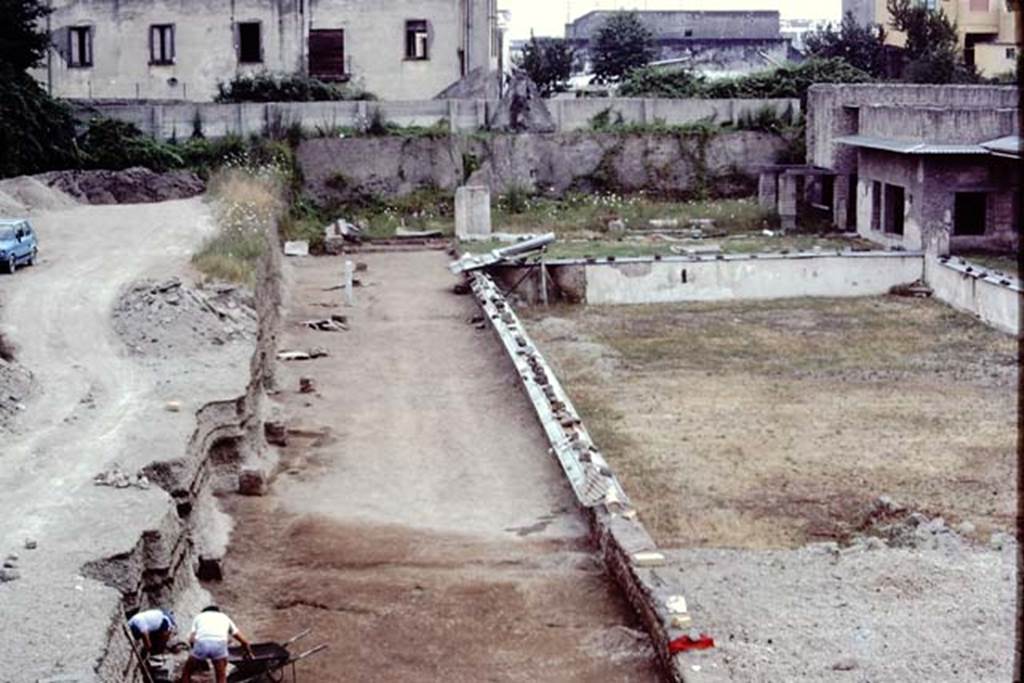Oplontis Villa of Poppea, July 1983. Statue base 10 being dug out, and discovery alongside it in the lapilli. 
Source: The Wilhelmina and Stanley A. Jashemski archive in the University of Maryland Library, Special Collections (See collection page) and made available under the Creative Commons Attribution-Non Commercial License v.4. See Licence and use details. Oplo0185
According to Wilhelmina - �There was great excitement at Oplontis when a headless statue of Nike/Victory was found in front of base 10. (X).  As we excavated the soil behind the statue bases on the north where there had been a considerable covering of lapilli, we found the soil contours of plantings with root cavities which we emptied. In them we found considerable charcoal, which when analysed proved to be oleander.�
See Jashemski, W.F., 2014. Discovering the Gardens of Pompeii: Memoirs of a Garden Archaeologist, (p.289).

