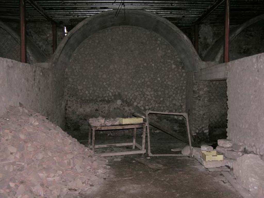 Oplontis, Villa of Lucius Crassius Tertius. March 2005. Vaulted storerooms lined both sides of the courtyard. 
Photo courtesy of Massimo Gravili.
According to the Soprintendenza, I bracci del peristilio furono utilizzati come deposito di contenitori da trasporto: più di 400 anfore, in massima parte da vino, erano appoggiate ai muri, capovolte ed inserite l'una nell'altra….Una simile destinazione a magazzini sembra attribuibile ad altri ambienti, con copertura a volta, allineati sul fronte sud. 
The arms of the peristyle were used as a storage depot for more than 400 amphorae, mostly used for wine. 
A similar use for warehousing appears to be attributable to other rooms, with vaulted ceilings, aligned on the southern front. 
See Villa on the Soprintendenza web site
