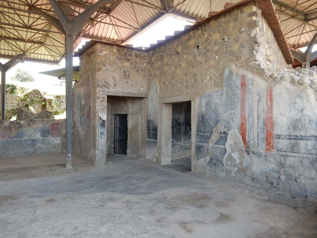 Stabiae, Secondo Complesso, June 2019. 
Room 14, looking towards south-west corner, with doorway into room 20, in centre, and into room 15, on right. Photo courtesy of Buzz Ferebee.
A large part of the mosaic flooring is missing, but the part remaining consists of a black mosaic with an external border of two white mosaic lines separated by black mosaic tiles. 


