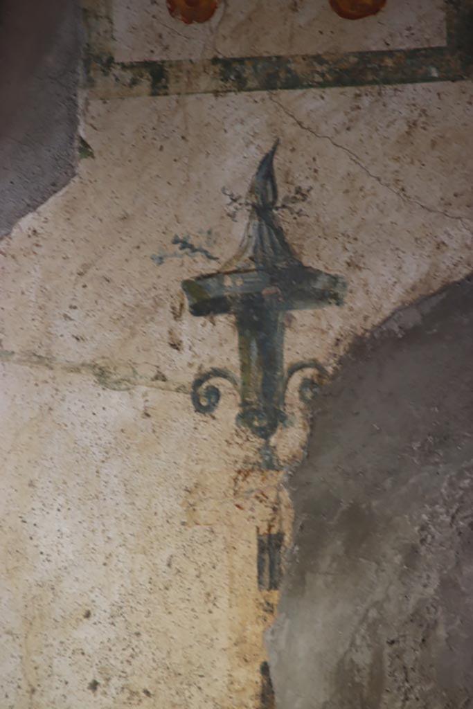 Stabiae, Villa Arianna, October 2022.  
Room M, detail of painted decoration above doorway in south-west corner. Photo courtesy of Klaus Heese.
